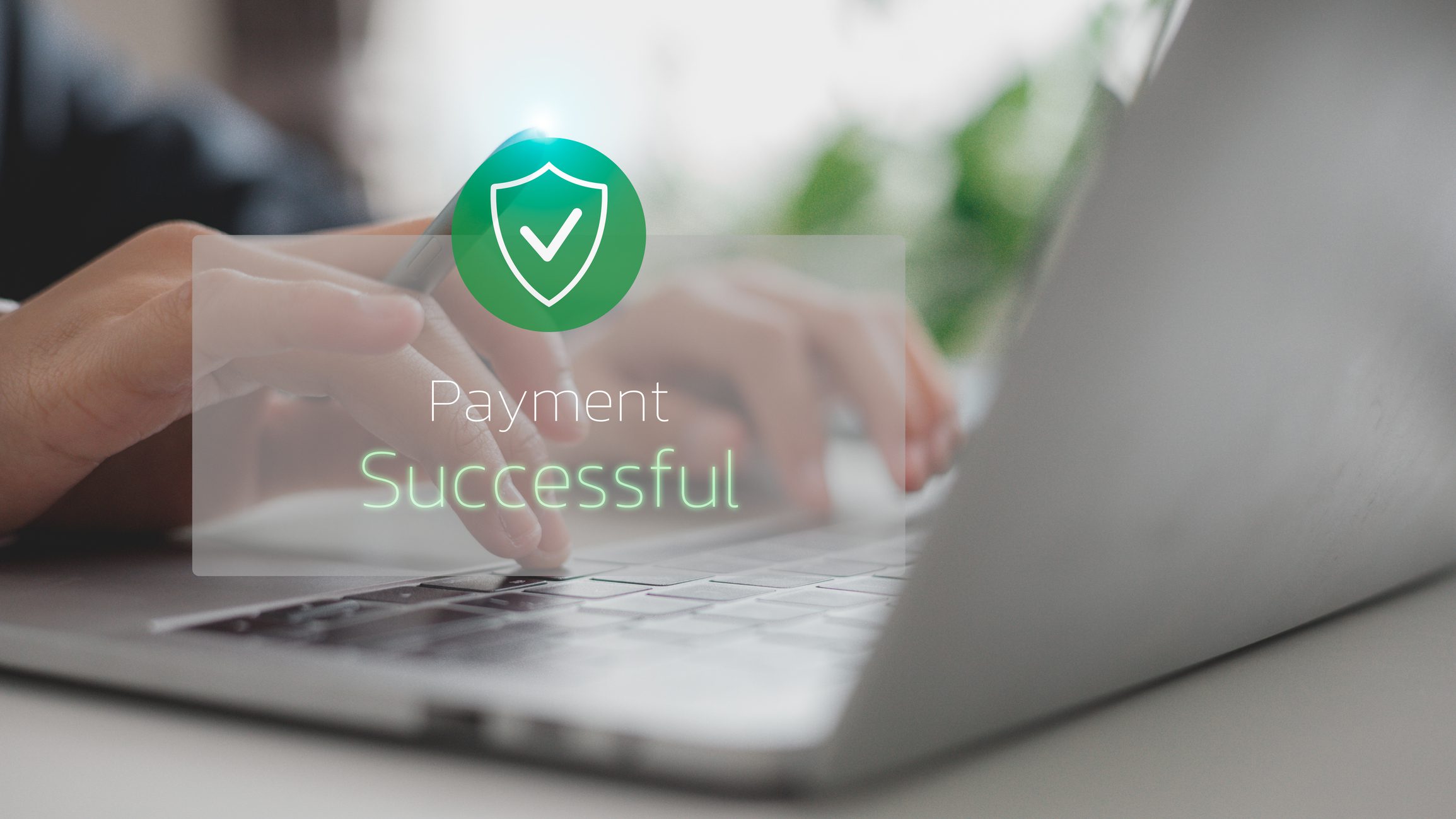 Hands typing on a laptop with a 'Payment Successful' notification.